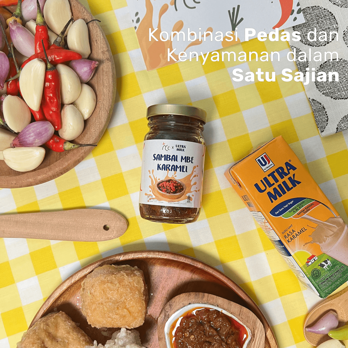 By NCC x Ultra Milk Sambal Mbe Karamel jar with caramel milk and spicy chili ingredients on a yellow checkered tablecloth